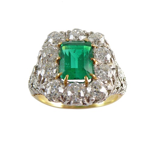 Early 20th century emerald and diamond cluster ring, c.1910, set with a 1.93ct rectangular emerald-cut Colombian stone,